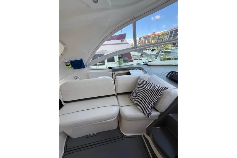 Slide: The Image of 2005 Cruisers Yachts 420 Express interior with white seating and striped pillow. - 7
