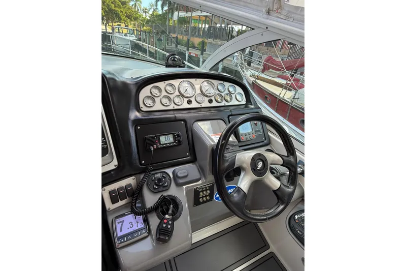 Slide: The Image of Helm of 2005 Cruisers Yachts 420 Express with steering wheel and control panel. - 10