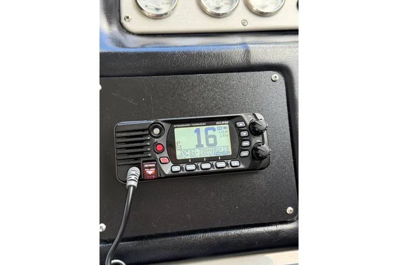 Slide: The Image of VHF radio on 2005 Cruisers Yachts 420 Express dashboard, displaying channel 16. - 13
