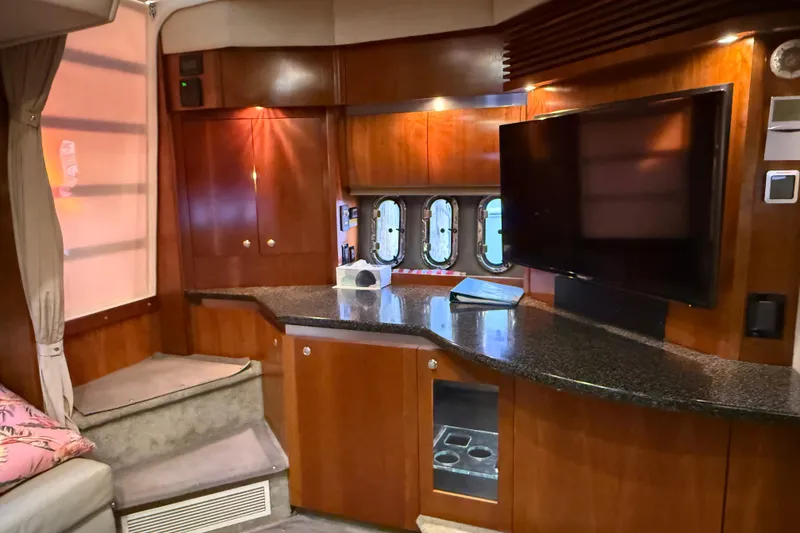 Slide: The Image of Luxurious interior of 2005 Cruisers Yachts 420 Express with wood cabinetry and modern amenities. - 21