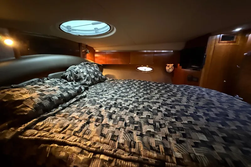 Slide: The Image of Luxurious cabin interior of 2005 Cruisers Yachts 420 Express with cozy bedding. - 24