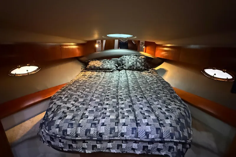 Slide: The Image of Luxurious cabin interior of 2005 Cruisers Yachts 420 Express with cozy bedding. - 25