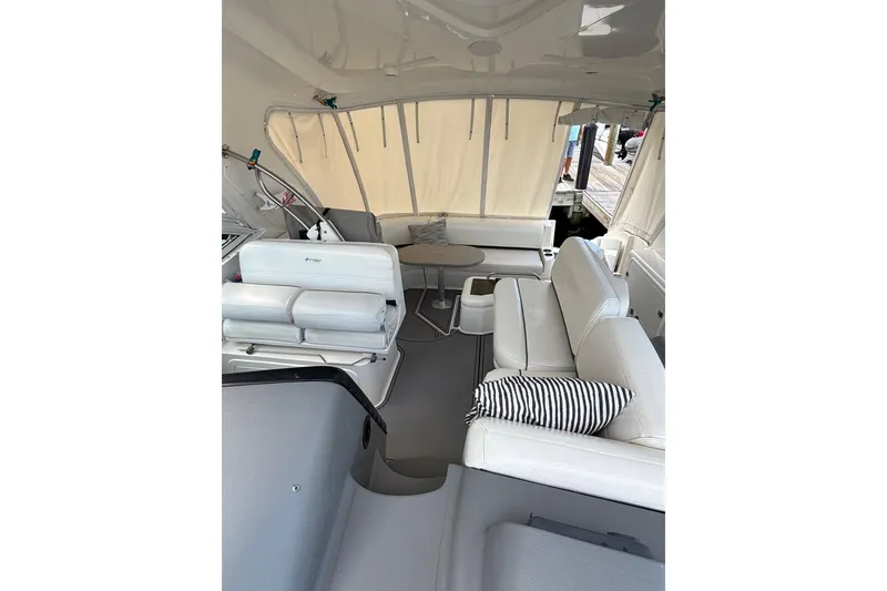 Slide: The Image of 2005 Cruisers Yachts 420 Express interior with white seating and striped pillow. - 5