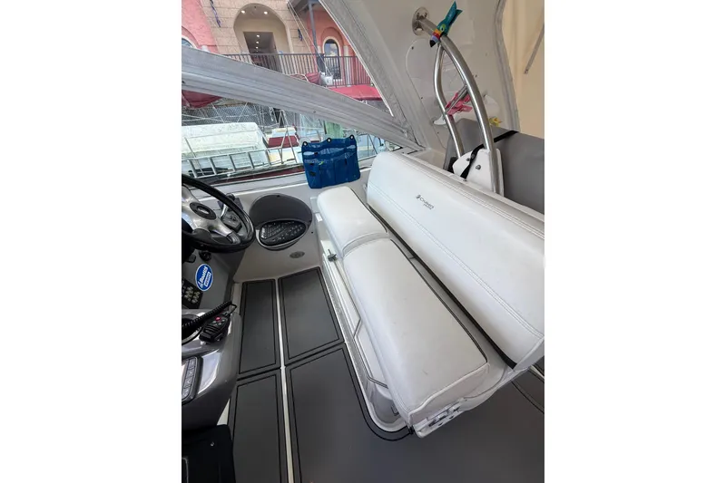 Slide: The Image of 2005 Cruisers Yachts 420 Express interior with white seating and helm controls. - 8