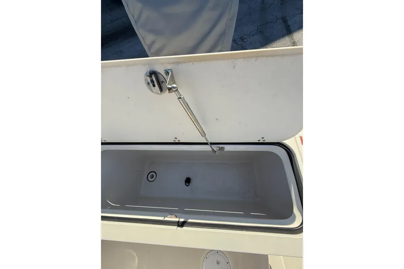 Slide: The Image of Open storage compartment on 2008 Pursuit C 250 Center Console boat. - 15