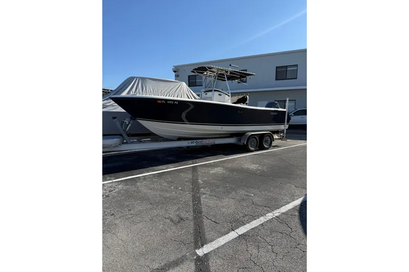 Slide: The Image of 2008 Pursuit C 250 Center Console boat on trailer in parking lot. - 2