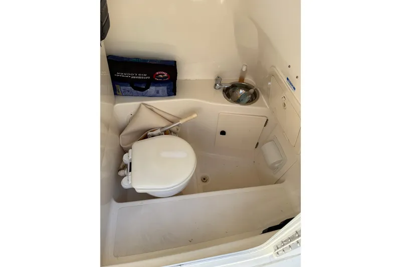 Slide: The Image of 2008 Pursuit C 250 Center Console boat interior with toilet and sink. - 21