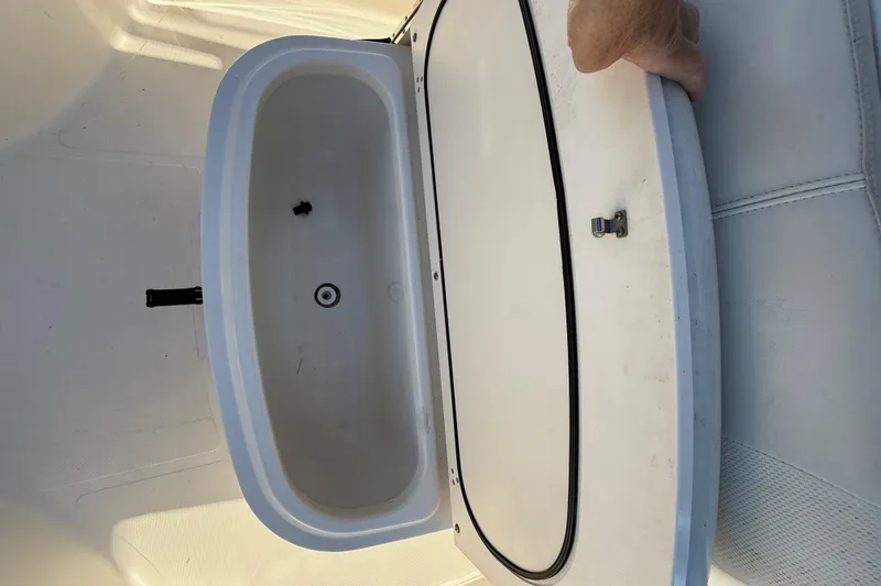 Slide: The Image of Open storage compartment on 2008 Pursuit C 250 Center Console boat. - 25