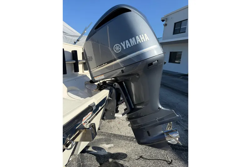 Slide: The Image of 2008 Pursuit C 250 Center Console with Yamaha outboard motor, parked outdoors. - 27