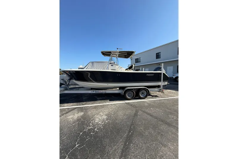 Slide: The Image of 2008 Pursuit C 250 Center Console boat on trailer, parked outdoors. - 28