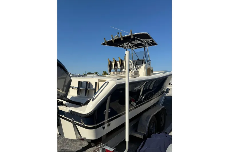 Slide: The Image of 2008 Pursuit C 250 Center Console boat on trailer under clear blue sky. - 5