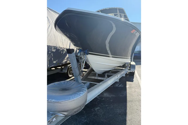 Slide: The Image of 2008 Pursuit C 250 Center Console boat on trailer, parked outdoors. - 6