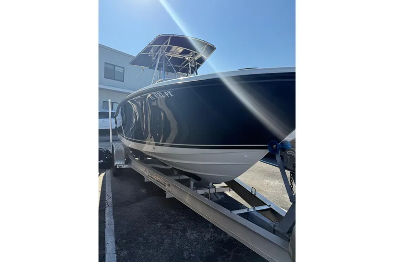 Slide: The Image of 2008 Pursuit C 250 Center Console boat on trailer under clear sky. - 7