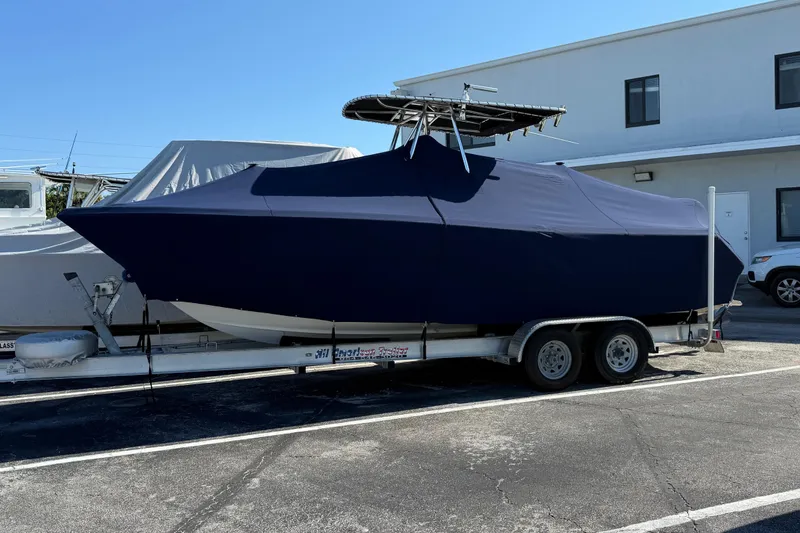 Slide: The Image of 2008 Pursuit C 250 Center Console boat covered on a trailer in a parking lot. - 8