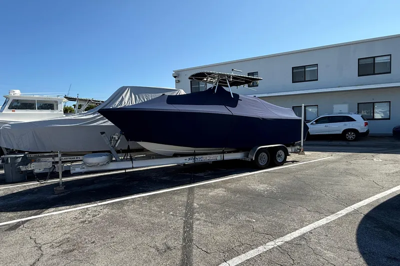 Slide: The Image of 2008 Pursuit C 250 Center Console boat covered on trailer in parking lot. - 9