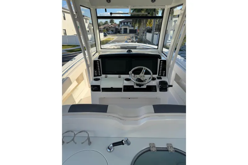 Slide: The Image of 2017 Robalo R302 Center Console boat helm with modern controls and navigation screens. - 13