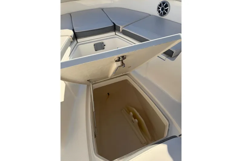 Slide: The Image of 2017 Robalo R302 Center Console boat with open storage compartment and cushioned seating. - 20