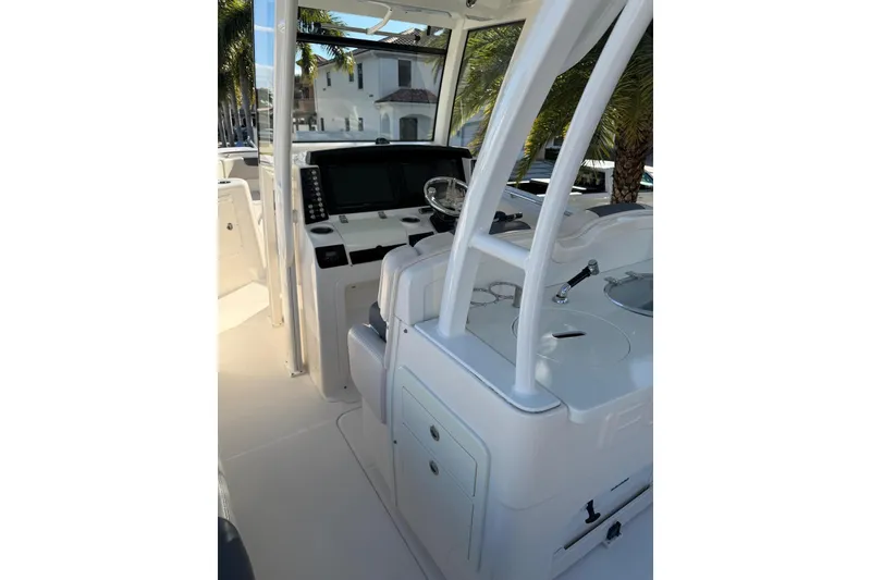 Slide: The Image of 2017 Robalo R302 Center Console boat interior with helm and seating area. - 7
