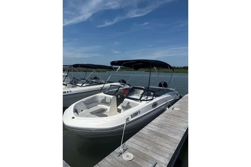 The Image of 2023 Bayliner VR6 Bowrider OB docked on a sunny day, featuring a sleek design. - 0