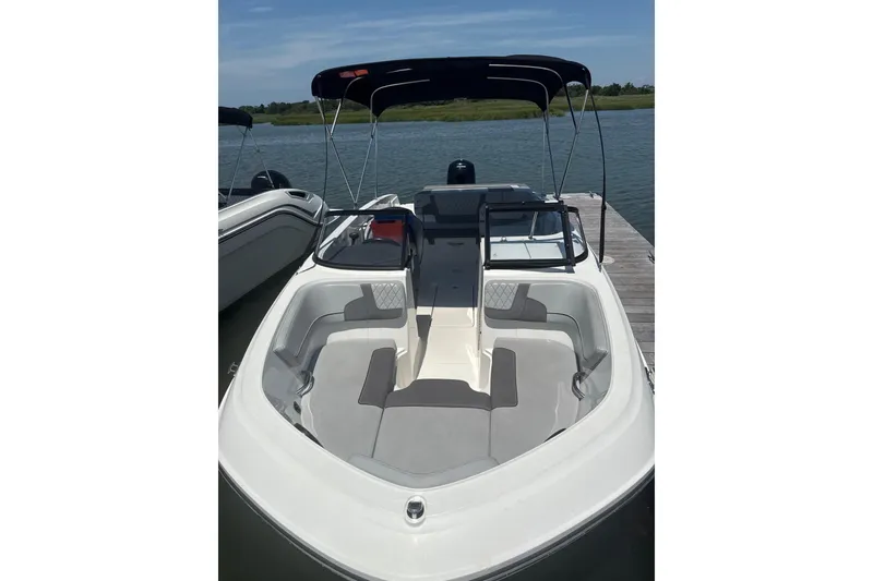 Slide: The Image of 2023 Bayliner VR6 Bowrider OB docked, featuring spacious seating and sleek design. - 2
