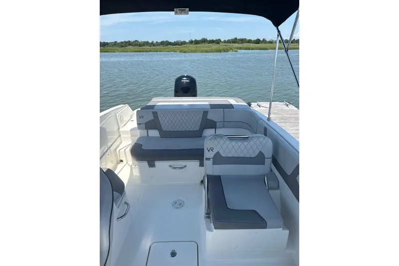 Slide: The Image of 2023 Bayliner VR6 Bowrider OB interior with seating, on a calm lake. - 4