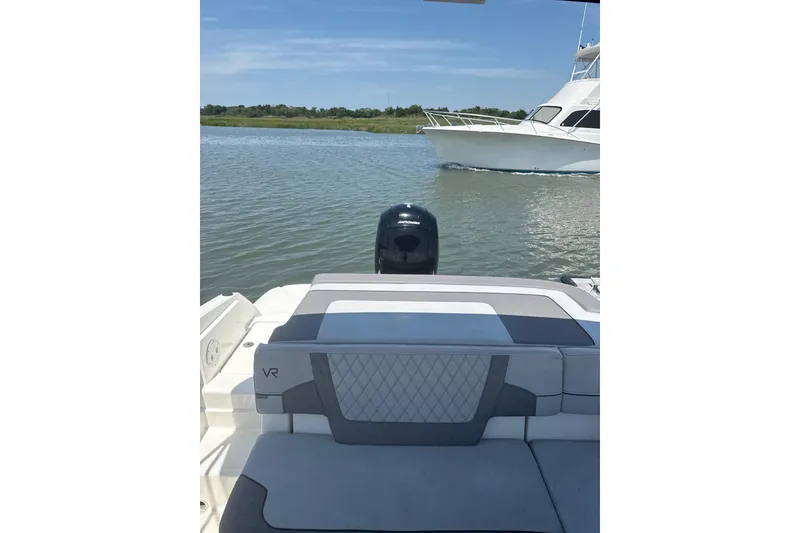 Slide: The Image of 2023 Bayliner VR6 Bowrider OB on calm water with another boat nearby. - 5