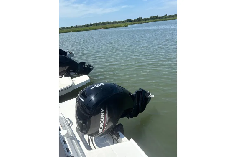 Slide: The Image of 2023 Bayliner VR6 Bowrider OB with Mercury outboard motor on a calm lake. - 9
