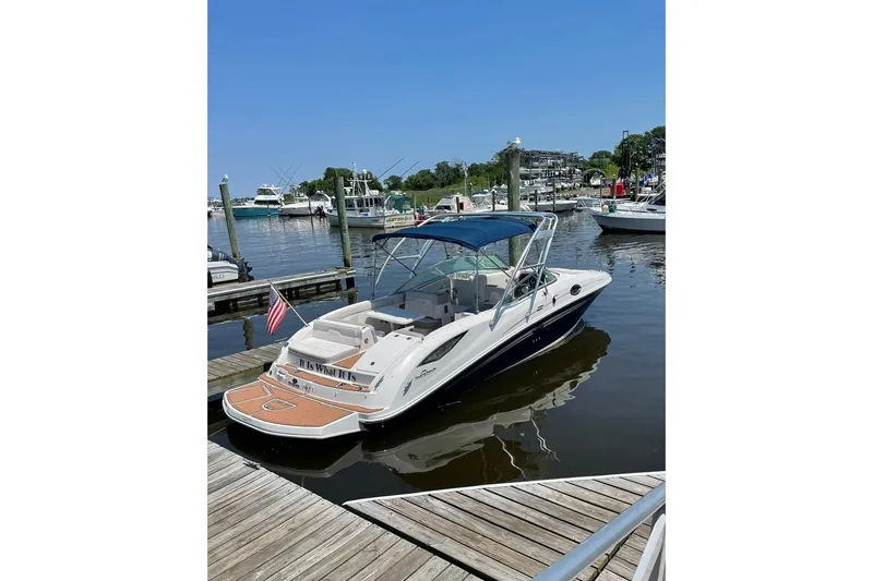 Slide: The Image of 2012 Sea Ray 300 Sundeck boat docked at marina with blue canopy. - 10
