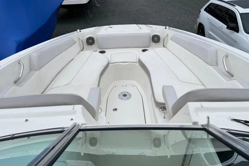 Slide: The Image of 2012 Sea Ray 300 Sundeck boat interior with white seating and spacious layout. - 4