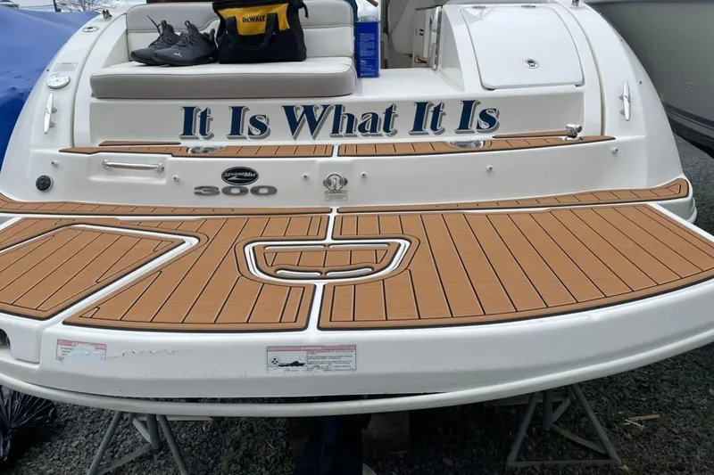 Slide: The Image of 2012 Sea Ray 300 Sundeck boat with teak deck and "It Is What It Is" text. - 5