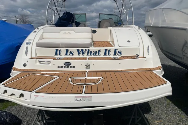 Slide: The Image of 2012 Sea Ray 300 Sundeck boat with "It Is What It Is" text on the stern. - 7