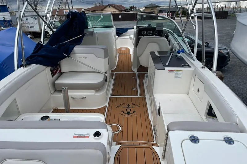 Slide: The Image of 2012 Sea Ray 300 Sundeck boat interior with white seating and wood-style flooring. - 9