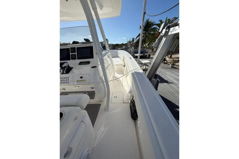 Slide: The Image of 2014 Intrepid 327 Center Console boat interior with helm and seating area. - 15