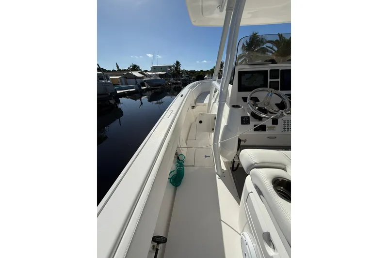 Slide: The Image of 2014 Intrepid 327 Center Console boat interior with steering wheel and controls. - 16