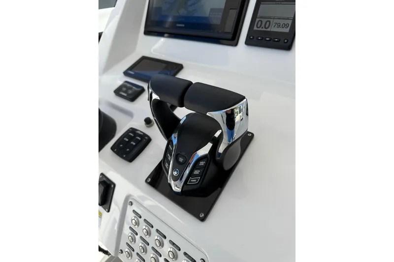 Slide: The Image of 2014 Intrepid 327 Center Console boat controls with modern dashboard and throttle. - 26