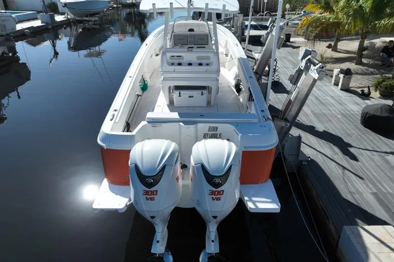 Slide: The Image of 2014 Intrepid 327 Center Console boat with twin 300 V6 engines docked at marina. - 4