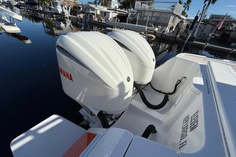 Slide: The Image of 2014 Intrepid 327 Center Console with twin Yamaha outboard engines docked at marina. - 6