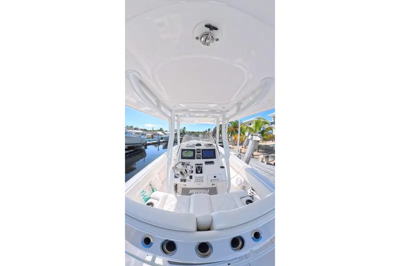 Slide: The Image of 2014 Intrepid 327 Center Console boat interior with modern dashboard and seating. - 9