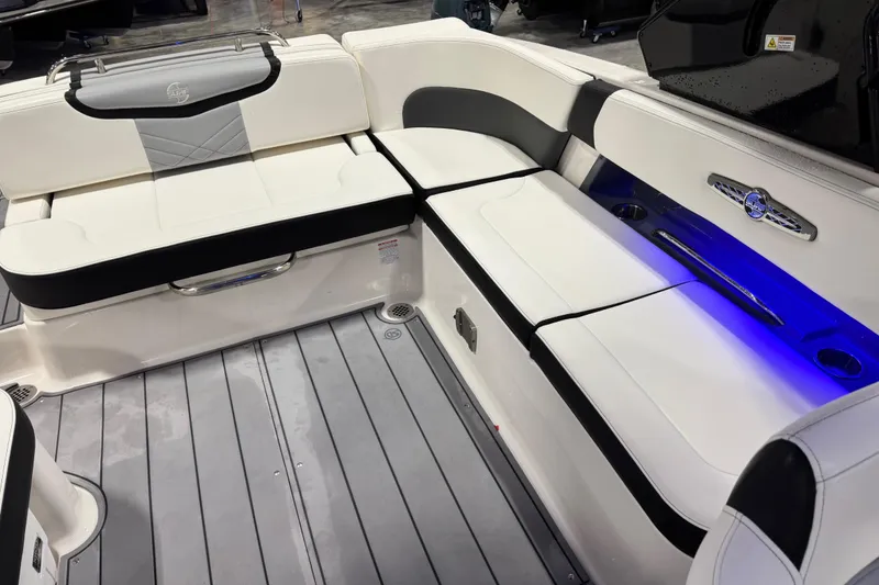 Slide: The Image of 2023 Chaparral 30 Surf boat interior with white seating and blue LED lighting. - 10