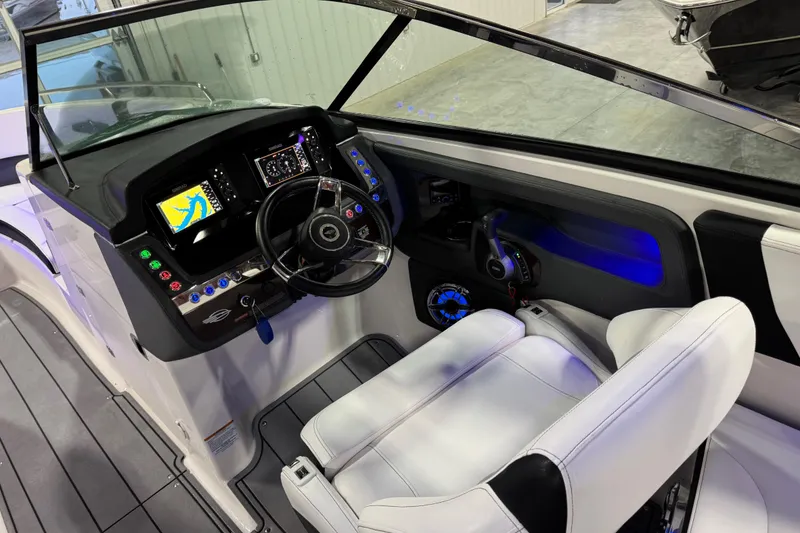 Slide: The Image of 2023 Chaparral 30 Surf boat cockpit with modern controls and navigation displays. - 13