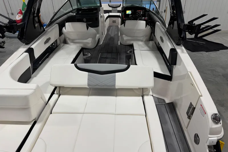Slide: The Image of 2023 Chaparral 30 Surf boat interior with luxurious white seating and modern dashboard. - 17