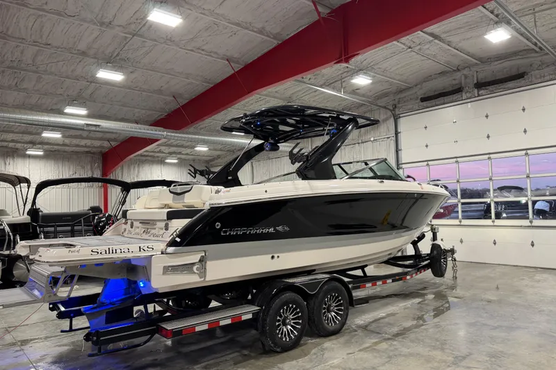 Slide: The Image of 2023 Chaparral 30 Surf boat on trailer in indoor showroom. - 3