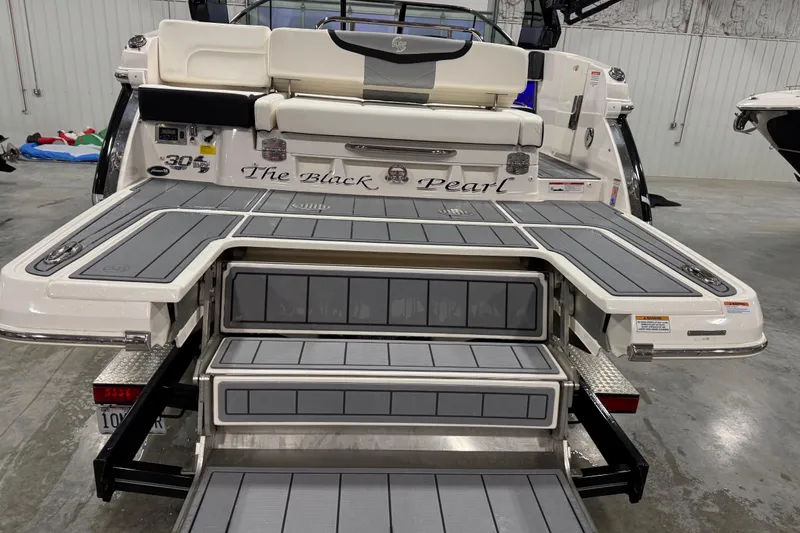 Slide: The Image of 2023 Chaparral 30 Surf boat, rear view with extended swim platform and seating. - 5