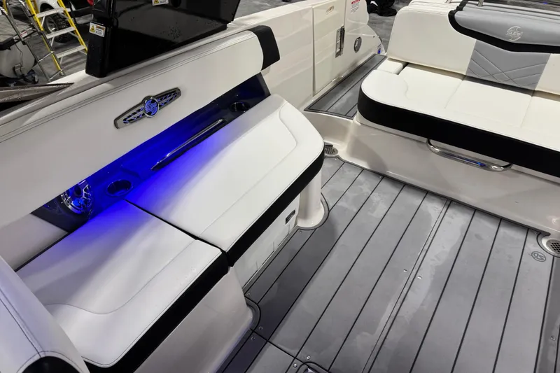 Slide: The Image of 2023 Chaparral 30 Surf boat interior with sleek seating and blue LED lighting. - 9