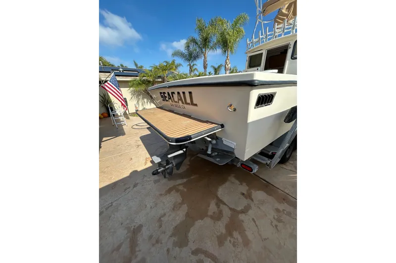 Slide: The Image of 2000 Parker 2520 XLD Sport Cabin boat with "Sea Call" name, docked in sunny San Diego. - 13