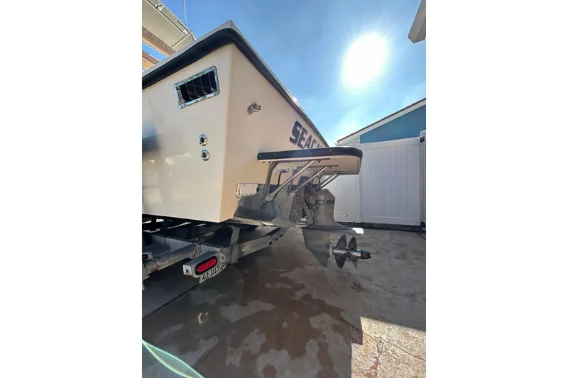 Slide: The Image of 2000 Parker 2520 XLD Sport Cabin boat on trailer, sunlit background. - 14