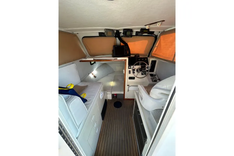 Slide: The Image of Interior of 2000 Parker 2520 XLD Sport Cabin boat with helm and seating. - 19