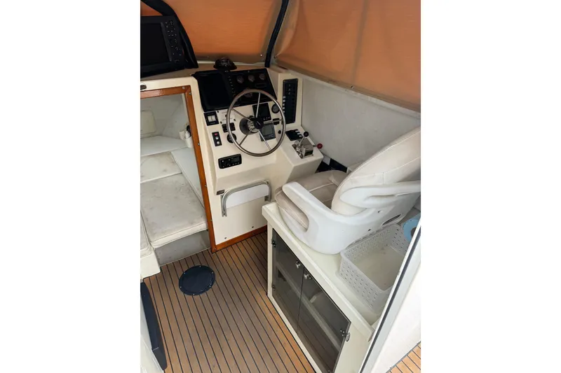 Slide: The Image of Interior of 2000 Parker 2520 XLD Sport Cabin with steering wheel and seating. - 21