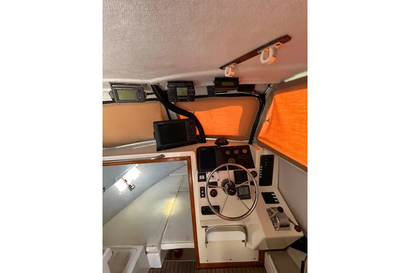 Slide: The Image of Interior of 2000 Parker 2520 XLD Sport Cabin with navigation equipment and steering wheel. - 22