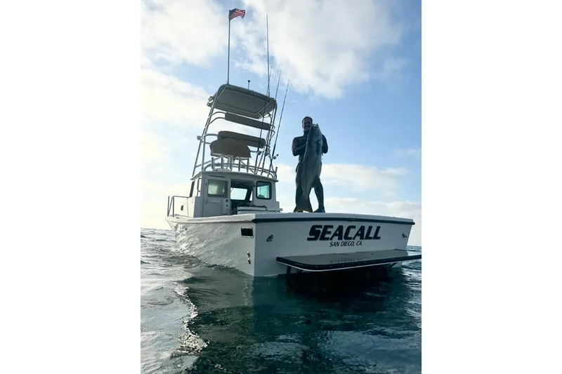 Slide: The Image of Man holding fish on Parker 2520 XLD Sport Cabin boat, "SEACALL," in San Diego waters. - 3